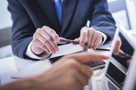 Image of business partners discussing documents and ideas at meetingの写真素材