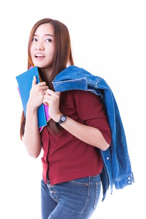Young asian student girl with book. Isolated on white background.の写真素材