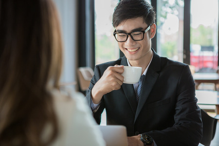 portrait of two business people discussing new project in coffee shopの写真素材