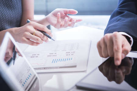Image of business partners discussing documents and ideas at meeting