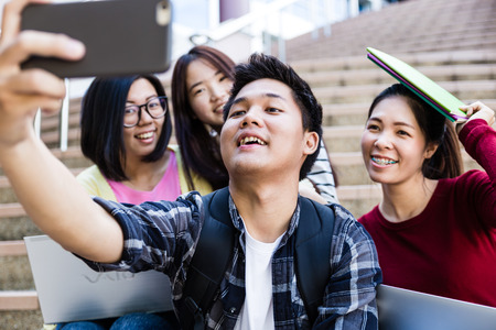 group of happy teen high school students outdoorsの写真素材