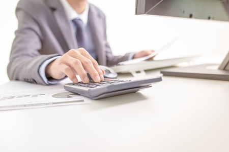 Businessman analyzing investment charts with computer. Accountingの写真素材
