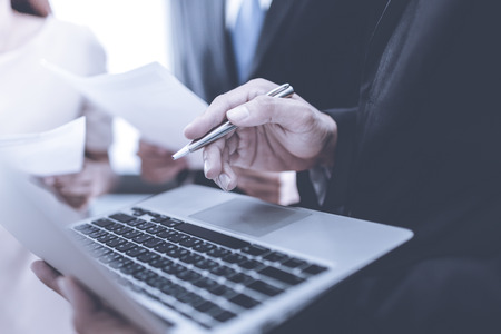 A business team of three sitting in office and planning workの写真素材