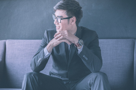 Businessman sitting on sofaの写真素材