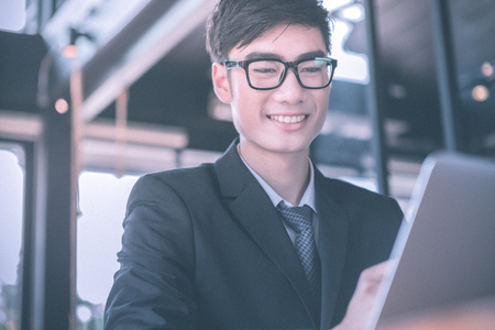 man, coffee, smile. Man in cafe looking into the camera. Interior portrait of a hot looking relaxed happy male modelの写真素材