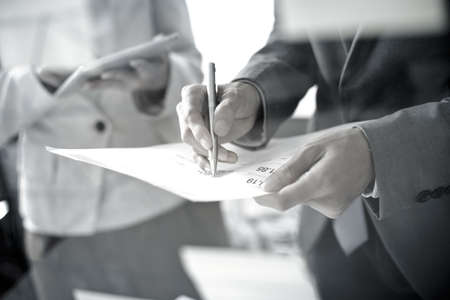 Business people discussing the charts and graphs showing the results of their successful teamworkの写真素材