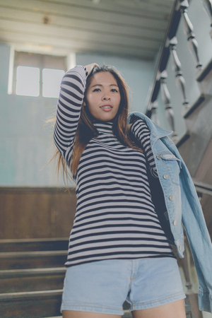 Young beautiful girl in abandoned houseの写真素材