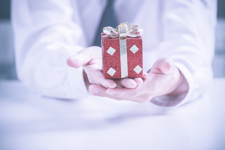 Business man offering a giftの写真素材