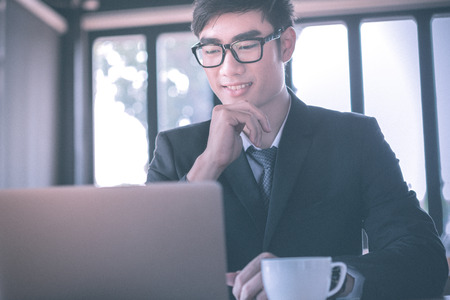 man, coffee, smile. Man in cafe looking into the camera. Interior portrait of a hot looking relaxed happy male modelの写真素材