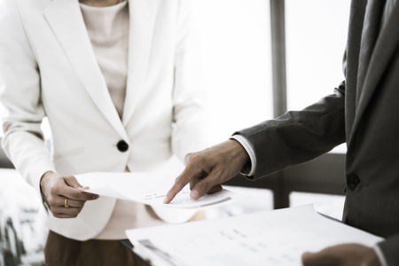 Business adviser analyzing financial figures denoting the progress in the work of the companyの写真素材
