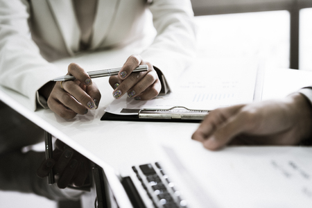 Business adviser analyzing financial figures denoting the progress in the work of the companyの写真素材