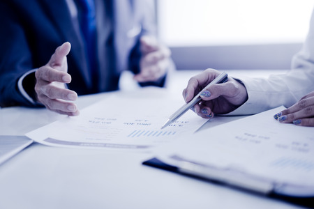 Business adviser analyzing financial figures denoting the progress in the work of the companyの写真素材
