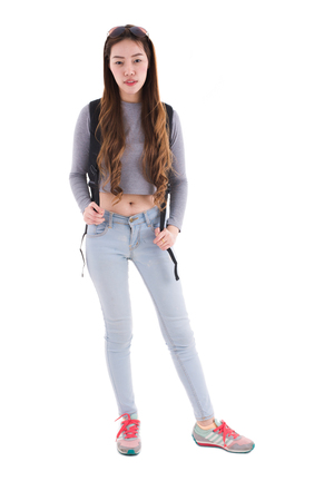 Traveling Asian woman with a backpack, full length portrait isolated on white background.の写真素材