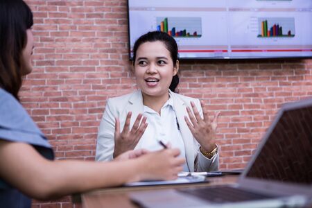 Image of business partners discussing documents and ideas at meeting.asiaの写真素材