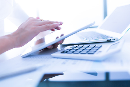 Close-up of young businesswoman hands working with touchpadの写真素材