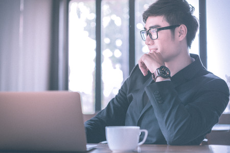 man, coffee, smile. Man in cafe looking into the camera. Interior portrait of a hot looking relaxed happy male modelの写真素材