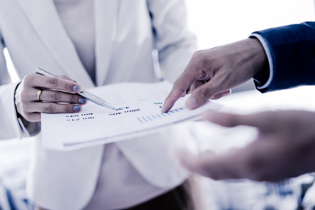 Business adviser analyzing financial figures denoting the progress in the work of the companyの写真素材