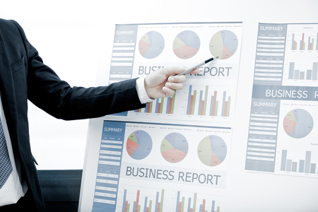 Business people discussing the charts and graphs showing the results of their successful teamworkの写真素材