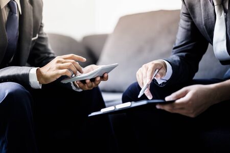 business partners discussing documents and ideas at meetingの写真素材