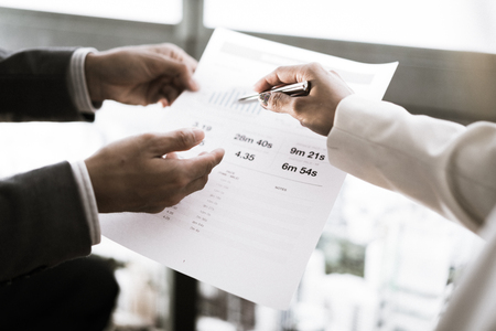 Business adviser analyzing financial figures denoting the progress in the work of the companyの写真素材