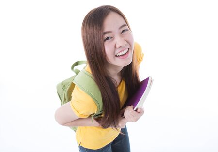 Young asian student girl with book. Isolated on white background.の写真素材