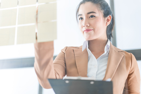 Asia business woman analyzing investment chart