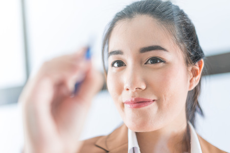 business woman writing on a glassの写真素材