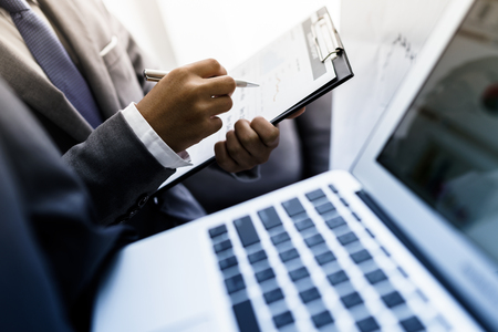 Business team working on a new business plan with modern digital computerの写真素材