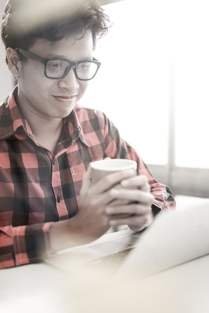 Businessman working laptop for new architectural project. Generic design notebook on the table. Blurred backgroundの写真素材