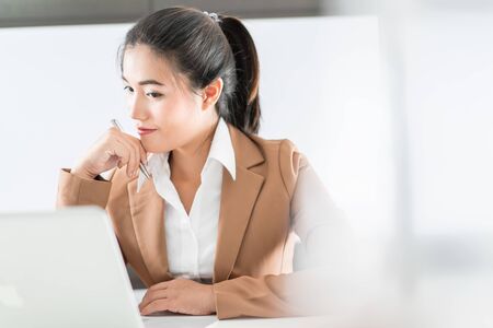 Young architect work project. Photo woman working with new startup project in modern loftの写真素材