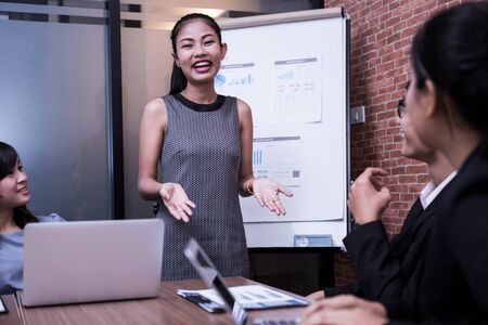 Image of business partners discussing documents and ideas at meeting.asiaの写真素材