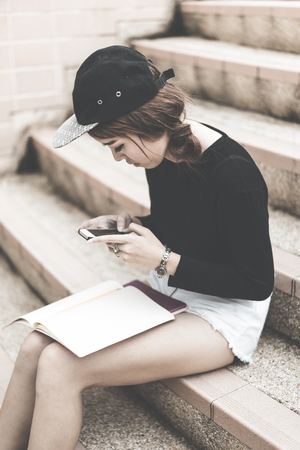 Smiling college student sitting on staircaseの写真素材