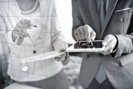 Business people discussing the charts and graphs showing the results of their successful teamworkの写真素材