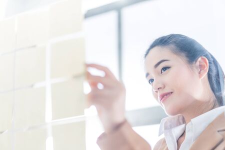 business woman writing on a glass