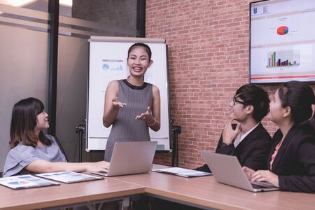 Image of business partners discussing documents and ideas at meeting.asiaの写真素材