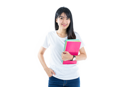 Young asian student girl with book. Isolated on white background.の写真素材