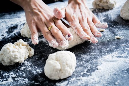 Making dough by female hands at bakeryの写真素材