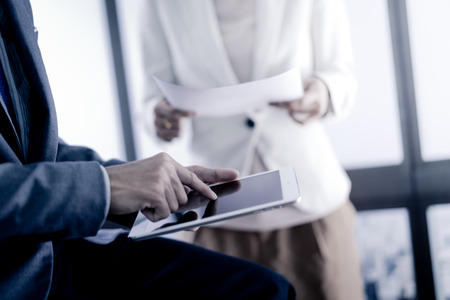 Business adviser analyzing financial figures denoting the progress in the work of the companyの写真素材