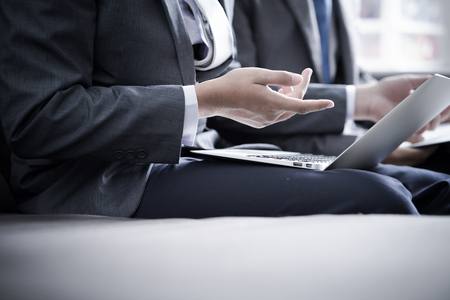 Image of two young businessmen discussing project at meetingの写真素材