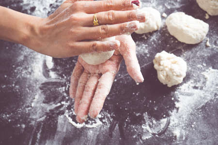 Making dough by female hands at bakeryの写真素材