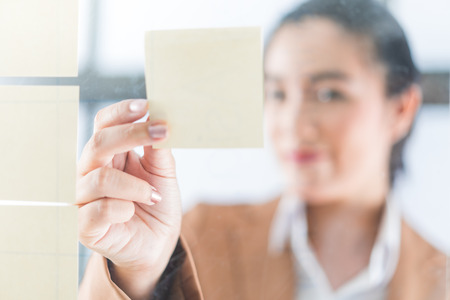 Asia business woman analyzing investment chartの写真素材