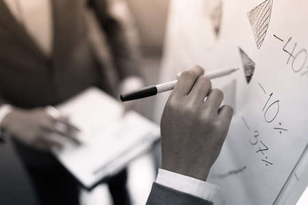 two young businessmen discussing project at meetingの写真素材