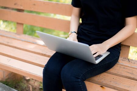 Beautiful young woman using laptop at outdoorの写真素材