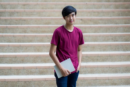 College asian student male sitting on staircaseの写真素材
