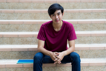 College asian student male sitting on staircaseの写真素材