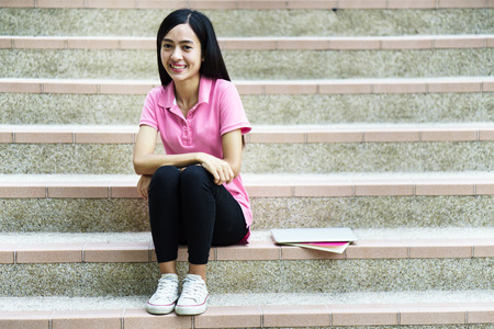 College asian student female sitting on staircaseの写真素材