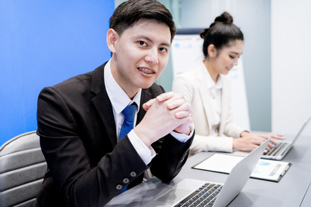 Businessman And Businesswomen Having Meeting In Office.Asianの写真素材