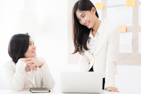 Two Businesswomen talking discussing concept in modern office. Asian peopleの写真素材