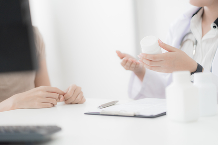 Doctor explaining diagnosis to her female patient. Asian peopleの写真素材