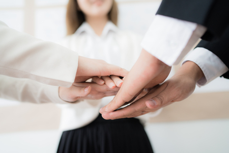 Business people group joining hands and representing concept of friendship and teamwork. Asian peopleの写真素材
